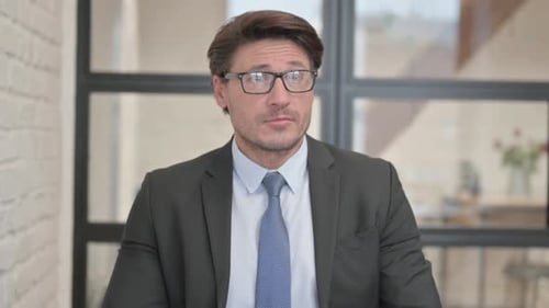 Man Checks Watch in Office Waiting