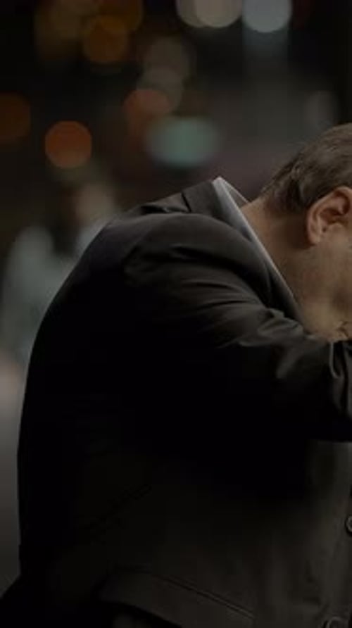 Man Standing in City at Night with Gray Hair