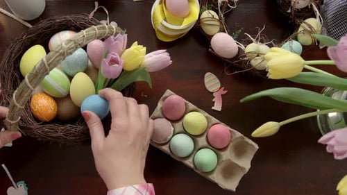 Decorating Easter Eggs: Woman Arranging Basket for Spring