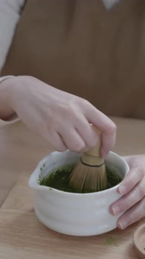 Mixing Matcha Green Tea with Bamboo Whisk