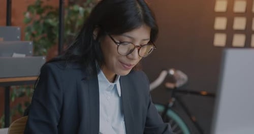 Middle Eastern Businesswoman Working with Computer Typing Concentrated on Work in Evening in Office