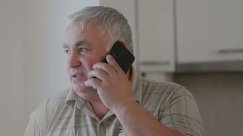 Man Talking on Phone Inside