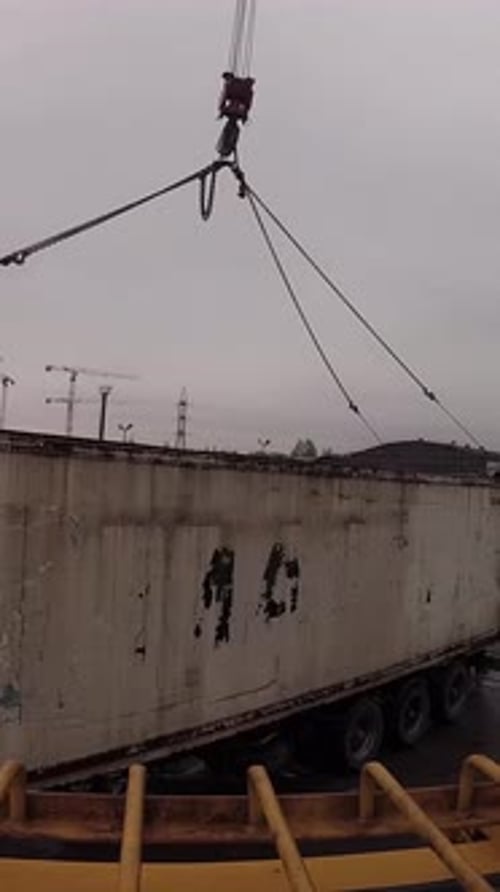 Crane Moves Shipping Container onto Truck