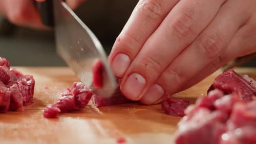 Chopping Raw Meat on Wooden Cutting Board