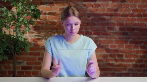 Female Holding Innovative Futuristic Tablet with Transparent Glass Screen and Watching Media with