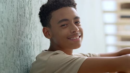 Teenage Boy Smiling and Looking into Camera