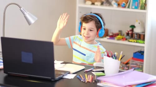 Boy Using Laptop Waves in Bright Room