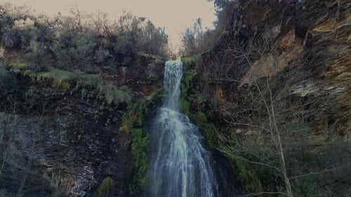 Fervenza da Pedreira Water Flowing Through Mossy Cliff In Folgoso do Courel, Spain. - aerial ascend