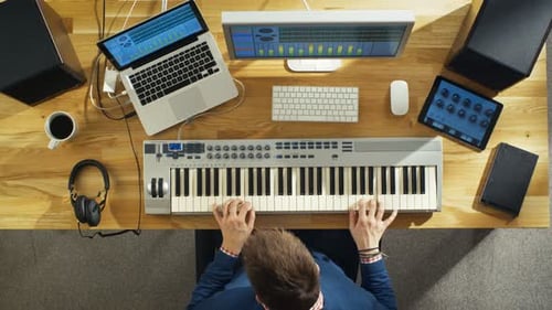 Top View of a Musician Creating Music at His Studio, Playing on a Musical Keyboard. His Studio is S