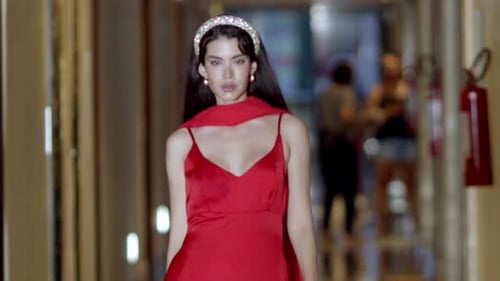 Elegant Woman in Red Dress Walks Hallway