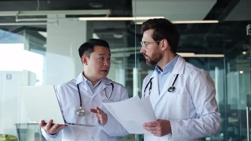 Workers of Hospital with Stethoscopes Using Laptop for Solving Working Issues