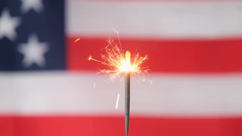 Lighting Sparkler in front of American Flag