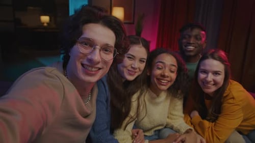 Happy Young Friends Taking a Selfie Together Indoors