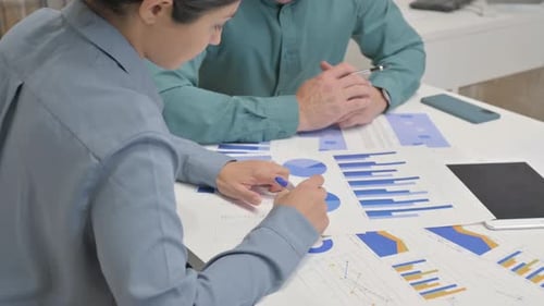 Close Up of Multi Ethnic People Doing Paperwork