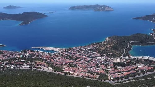 Aerial pan across seaside town of Kas on Mediterranean coast, Turkey