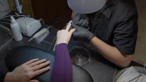 Top Down Close Up Of Cuticle Trimming With Tweezers During Manicure