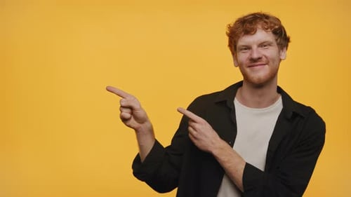 Young Adult Points to the Left and Smiles