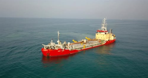 Red and Beige Ship Sailing in Calm Ocean