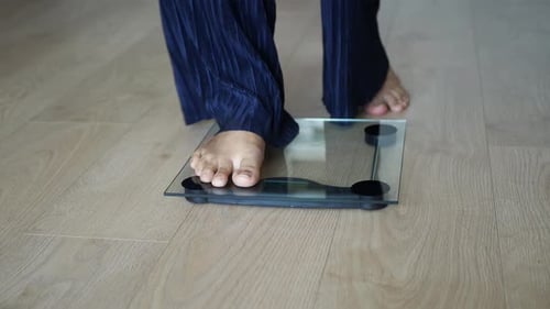 Woman's Feet on Weight Scale Close Up