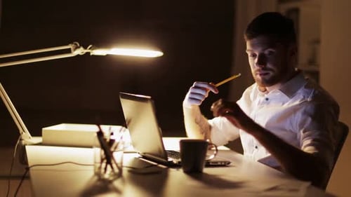 Man working late at desk with computer