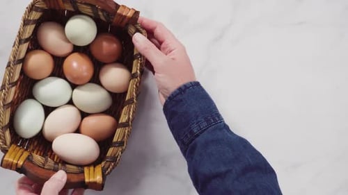 Overhead of Basket Full of Colored Eggs