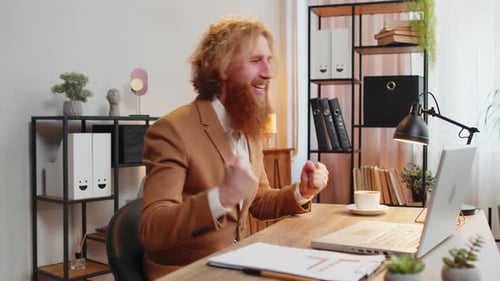 Man Celebrates Success At Computer