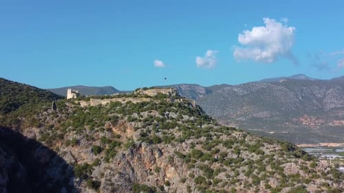 view of the mountains from above, castle with flag on the high