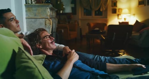Loving Couple Relaxing on Couch at Night