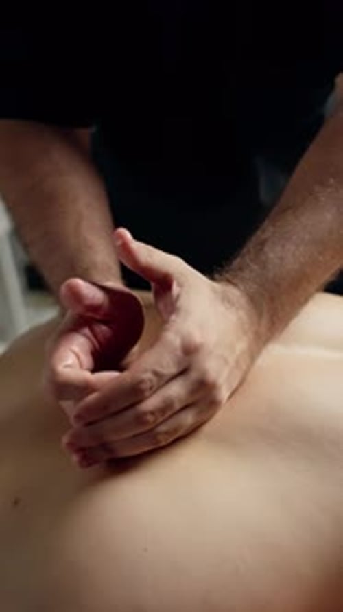 Professional Masseur Performing Deep Tissue Back Massage Applying Therapeutic Pressure for Holistic