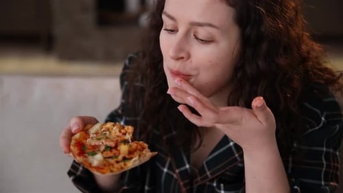 Woman Eating Slice of Pizza Close Up