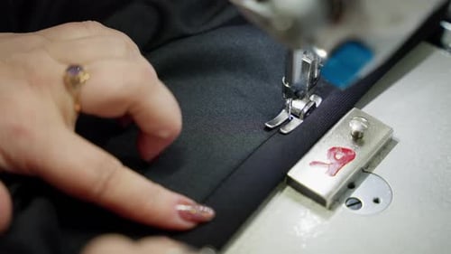 Close Up of Sewing Machine with Woman's Hands