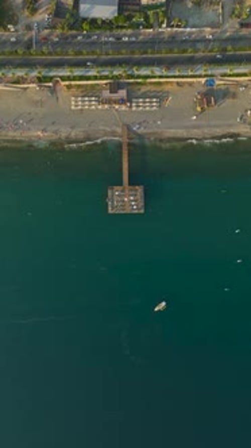 Vertical Video Soaring Over the Pier's Charm Aerial Views of a Wooden Hotel Pier in the