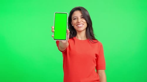 Smiling Woman Showing a Green Screen Smartphone