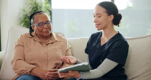 Woman Doctor Explaining Diagnosis to a Senior Patient