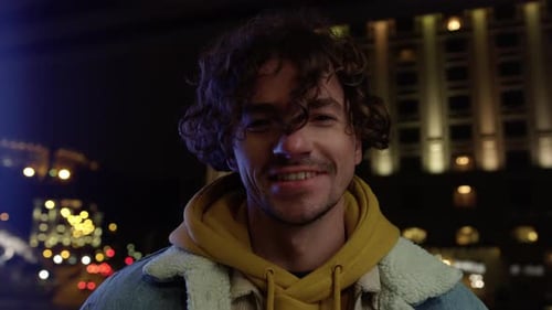 Portrait of Cheerful Man Laughing on City Street at Night. Smiling Guy