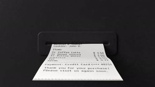 Credit card receipt emerging from coffee POS machine on black background