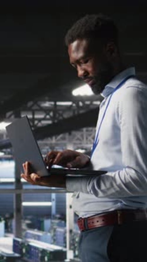 Vertical Video Happy Technician and Colleague in Data Center Reviewing AI LLM Visualizations