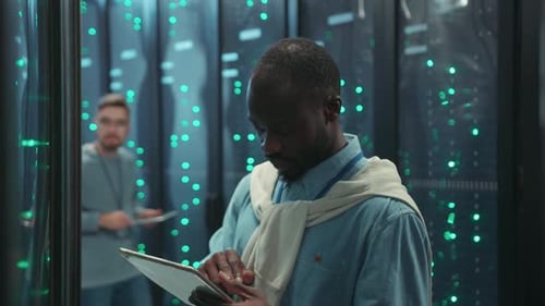 Two Men Working with Tablets in Server Room