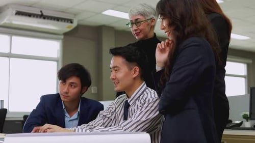 Enthusiastic Team Collaborates and Celebrates Success at Office