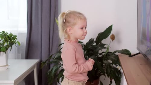 A Girl with a Cochlear Implant Watches TV and Hears Sounds