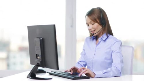 Business and Office Concept - Smiling Female Helpline Operator with Headphones And