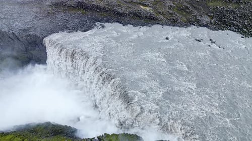 Aerial drone view of Dettifoss waterfall plunging into Jokulsargljufur canyon in Northeast Iceland.