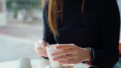 Woman in the cafe sits at table