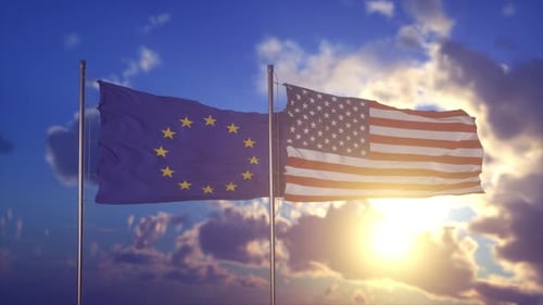 European Union and United States Flags Waving in Sunset Sky