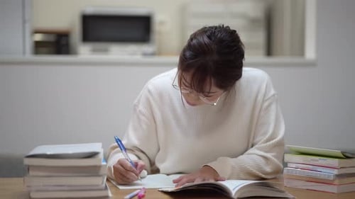 Focused Young Adult Studying Hard at Home