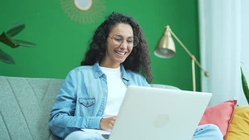 Woman Video Calling on Laptop in Modern Home