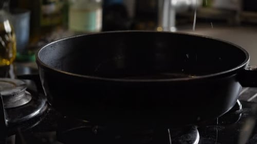 Pouring Oil and Egg into Hot Pan