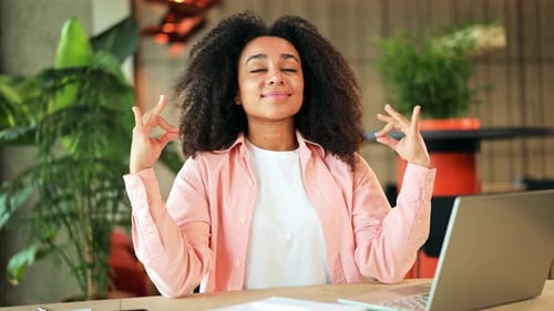 Calm Woman Meditating in a Peaceful Office Environment for Stress Relief