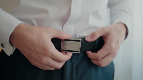 Man Fastening Stylish Belt Before Work Indoors