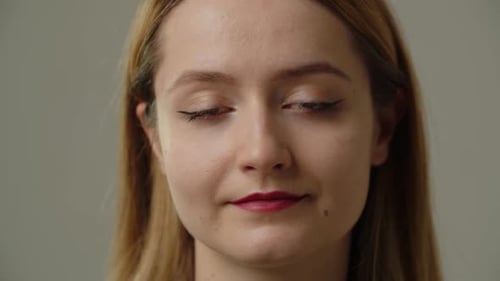 Young Woman Wearing Makeup Looking at Camera